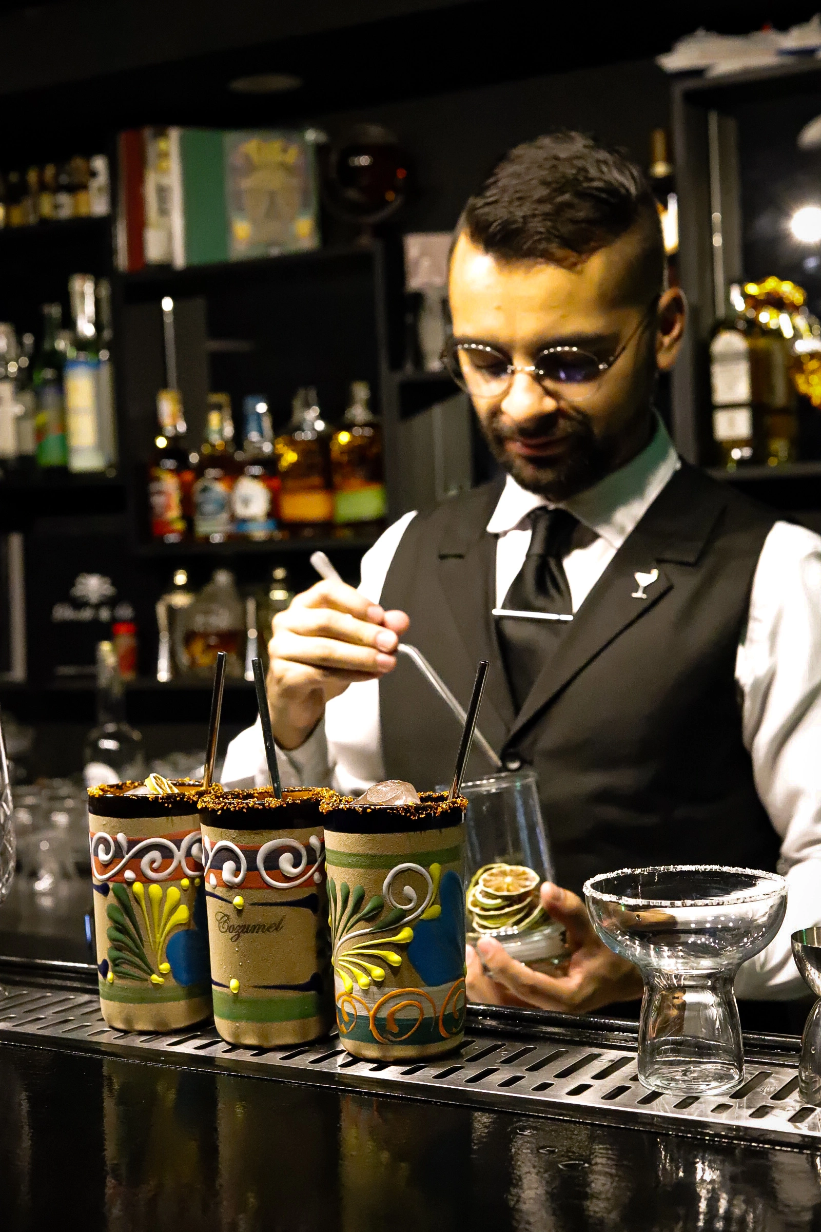 Bartender preparing craft cocktail at The Hermit Bar Pasto